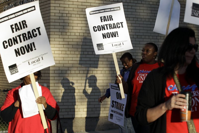 Chicago teachers walk a picket line outside Benjamin Banneker Elementary School in Chicago, early Monday, Sept. 10, 2012, after they went on strike for the first time in 25 years. 