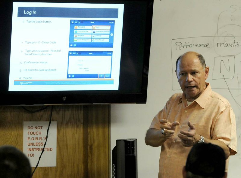 Randall Harrison, a safety and compliance instructor for P.A.M. Transport Inc., instructs a class of new drivers on the use of electronic on-board recording devices earlier this month in Tontitown. 