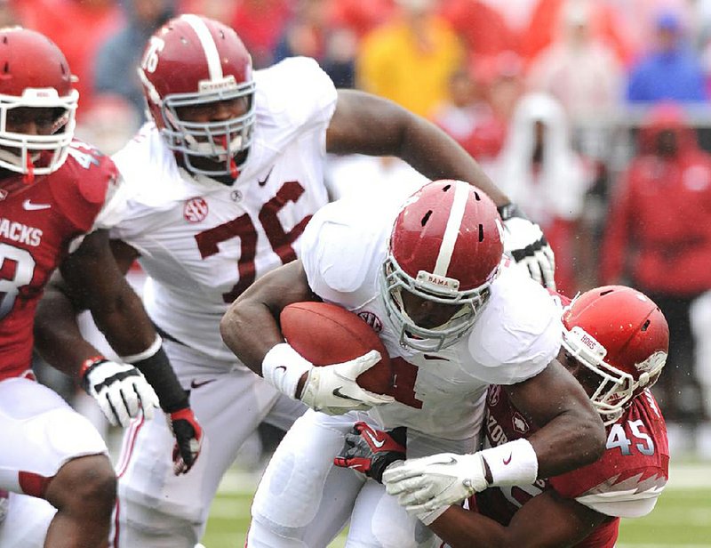 Arkansas linebacker Alonzo Highsmith (right), shown tackling Alabama’s T.J.Yeldon during last Saturday’s 52-0 loss to the Crimson Tide, helped tear down a season schedule in the Razorbacks’ weight room, leaving only Saturday’s game against Rutgers. 