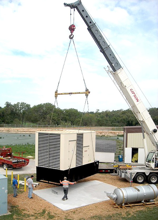 A new one megawatt diesel generator was lifted into place by cranes at Decatur’s wastewater treatment plant on Thursday. The large tank in the foreground of the picture is the generator’s muffler.