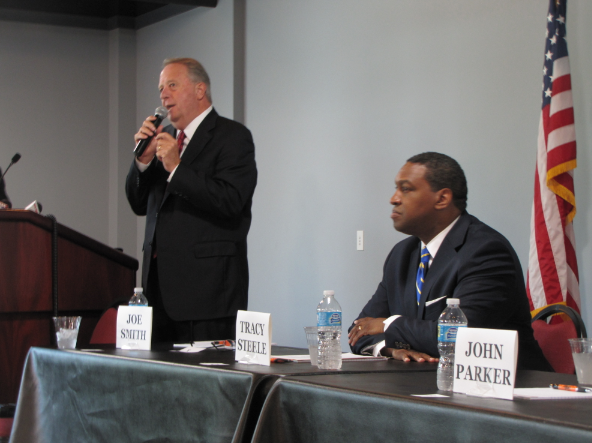 FILE - Joe Smith speaks while state Rep. Tracy Steele looks on during a forum for North Little Rock mayoral candidates on Sept. 20.