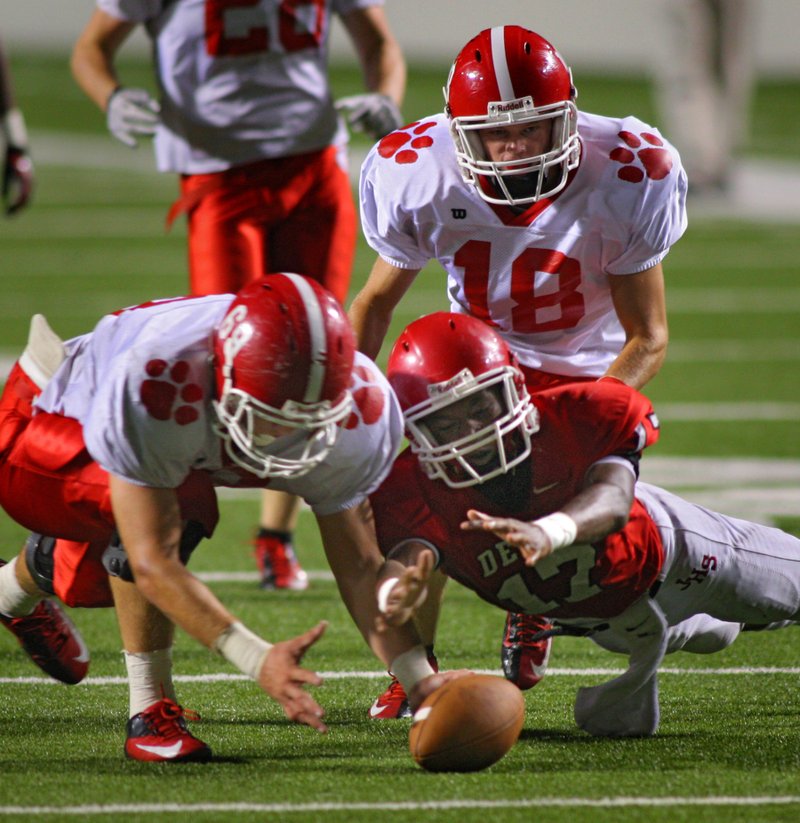 Jacksonville’s Aaron Smith (right), shown against Cabot in the Red Devils’ season-opening game, ran 30 times for 185 yards and 1 touchdown last week.