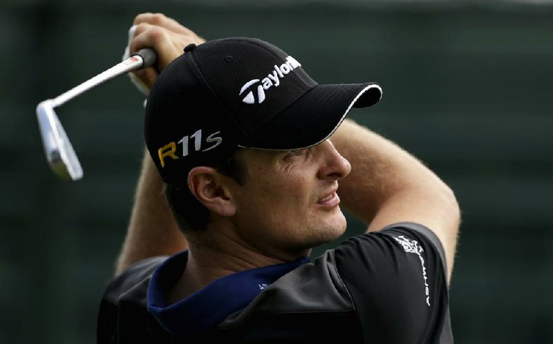 First-round leaders Justin Rose (above) and Tiger Woods (right) used a rash of birdies to shoot a 4-under-par 66 and take a oneshot lead in the PGA Tour Championship. 