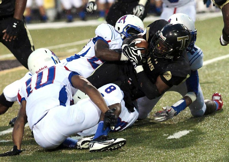 A host of Arkadelphia defenders pull down Hot Springs’ Quinn Coleman (right) during Friday’s 38-14 Badgers victory in Hot Springs. Arkadelphia is off to a 4-0 start for the first time since 1987. 