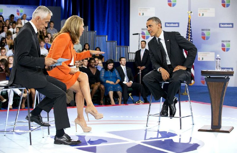 President Barack Obama participates in a town hall hosted by Univision and Univision news anchors Jorge Ramos, left and Maria Elena Salinas, center, at the University of Miami, Thursday, Sept. 20, 2012, in Coral Gables, Fla.  (AP Photo/Carolyn Kaster)