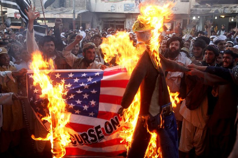 Pakistani protesters angry over an anti-Islam film burn a replica of a U.S. flag and an effigy of President Barack Obama on Thursday in the town of Chaman along the Afghanistan border. 