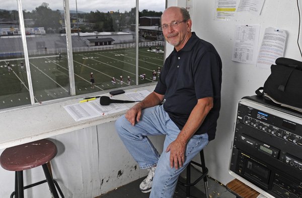 Bill Carter sits in the announcer’s box Sept. 7 at Jarrell William Bulldog Stadium in Springdale. Carter has been the football announcer for Springdale High for 30 years. He is the voice of the Springdale Bulldog football and basketball teams as well as the Springdale Har-Ber Wildcat football team. 