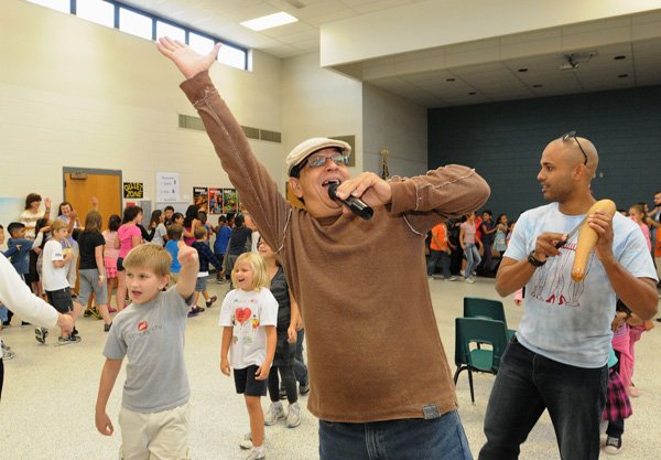 Gary Nunez, in cap, and Emanuel Santana with the percussion band, Plena Libre, of Puerto Rico, lead Mathias Elementary students in a conga line dance during their performance Thursday at the school. 