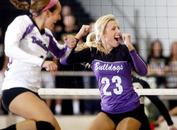 Andrea Kathol, left, a Fayetteville senior, and junior Cassidy Ginger celebrate a point against Bentonville on Thursday at Bentonville. 