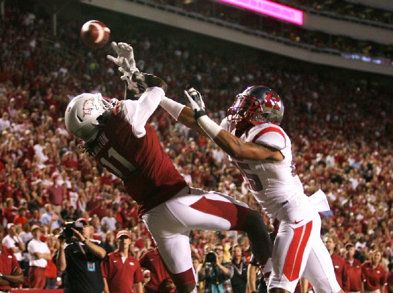 Rutgers defensive back Brandon Jones breaks up a pass in the end zone intended for Arkansas wide receiver Cobi Hamilton during the third quarter on Saturday at Reynolds Razorback Stadium in Fayetteville. Hamilton caught 10 passes for an SEC-record 303 yards and 3 touchdowns. 