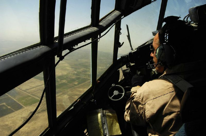 An Iraqi air force pilot looks out of a C-130 in this photograph from 2008, the year Little Rock Air Force Base personnel first began training Iraqis on the cargo planes. 