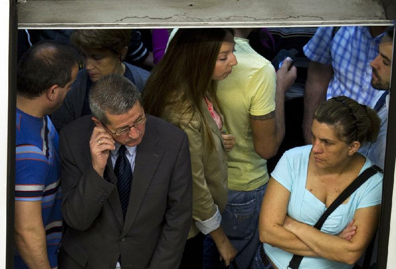 Commuters wait on a train Friday during a subway and bus strike in Madrid. Transit workers staged the strike to protest government wage cuts and changes. 