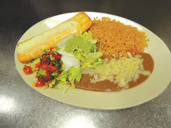 Traditional dishes such as chimichangas are served with home-made refried beans, rice and pica de galla
