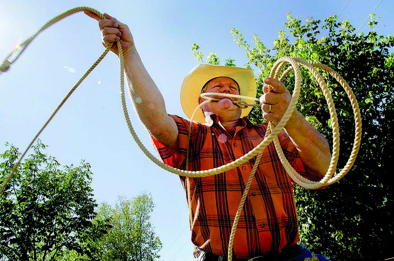 Rick Whorton demonstrates his roping technique at his home near Springdale. While roping seems easy, he says it takes time — and money — to master. 