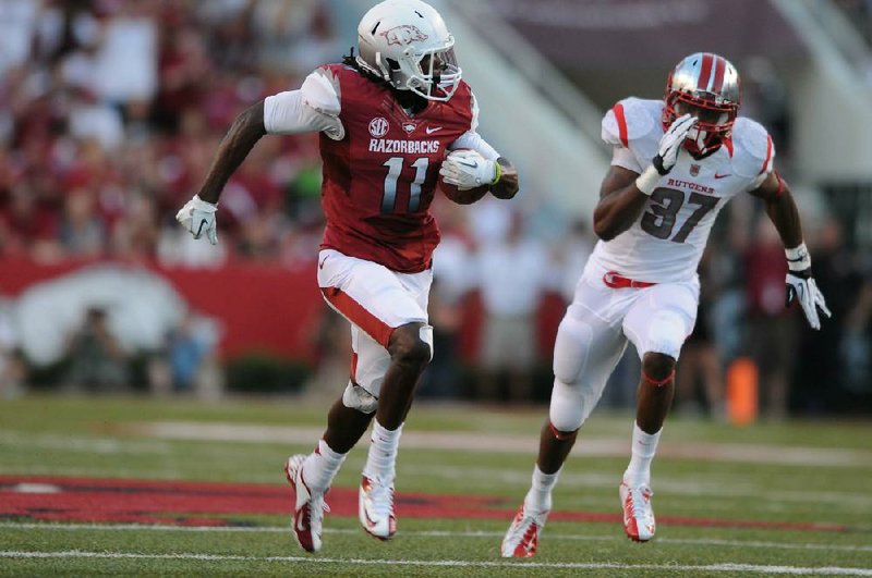 Arkansas wide receiver Cobi Hamilton (11) shared SEC co-offensive player of the week honors with South Carolina quarterback Connor Shaw. Hamilton caught 10 passes for an SEC-record 303 yards and 3 touchdowns in the Razorbacks’ 35-26 loss to Rutgers on Saturday night. 