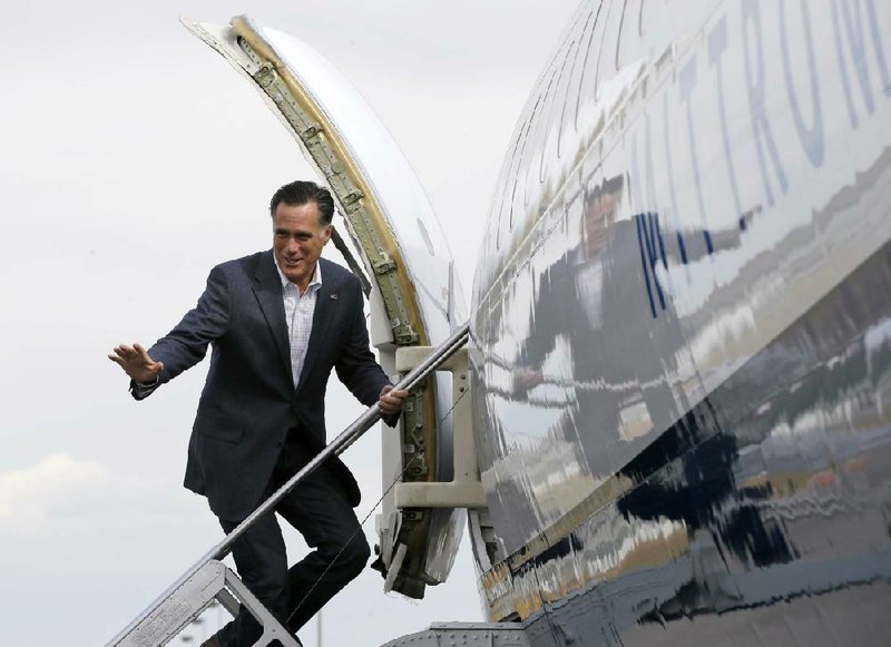 Mitt Romney boards his plane Monday in Denver heading to Pueblo, Colo., where he critiziced President Barack Obama’s foreign policy in the Middle East. 