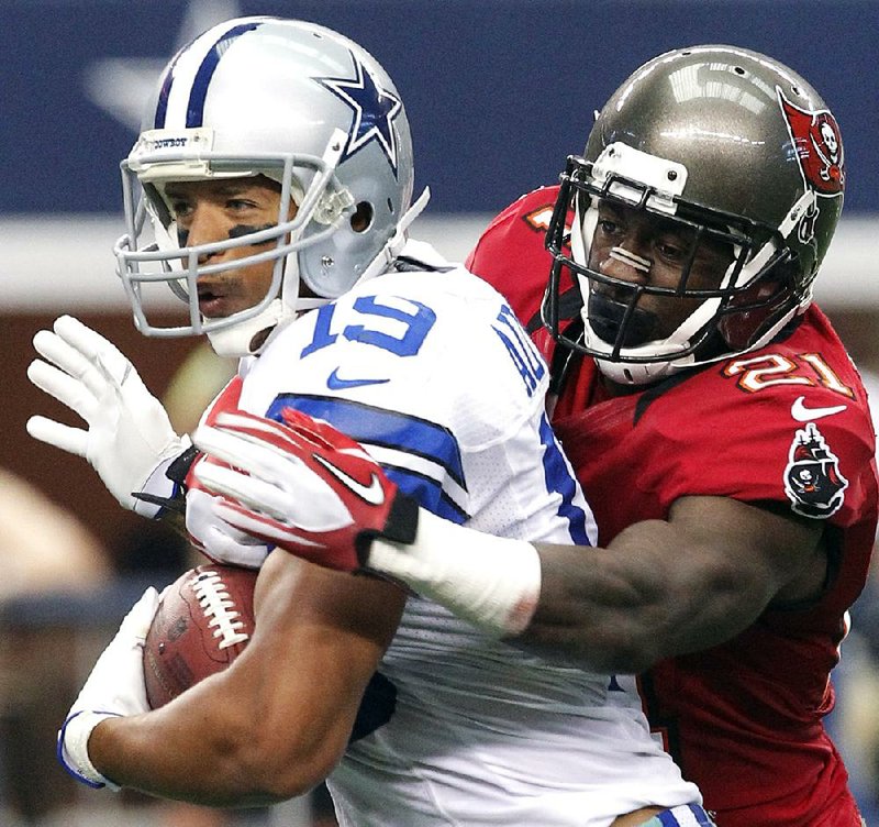 Dallas Cowboys wide receiver Miles Austin (19) is tackled by Tampa Bay Buccaneers defensive back Eric Wright (21) during the second half of Sunday’s game in Arlington, Texas. Austin finished with five catches for 107 yards and the Cowboys won 16-10. 