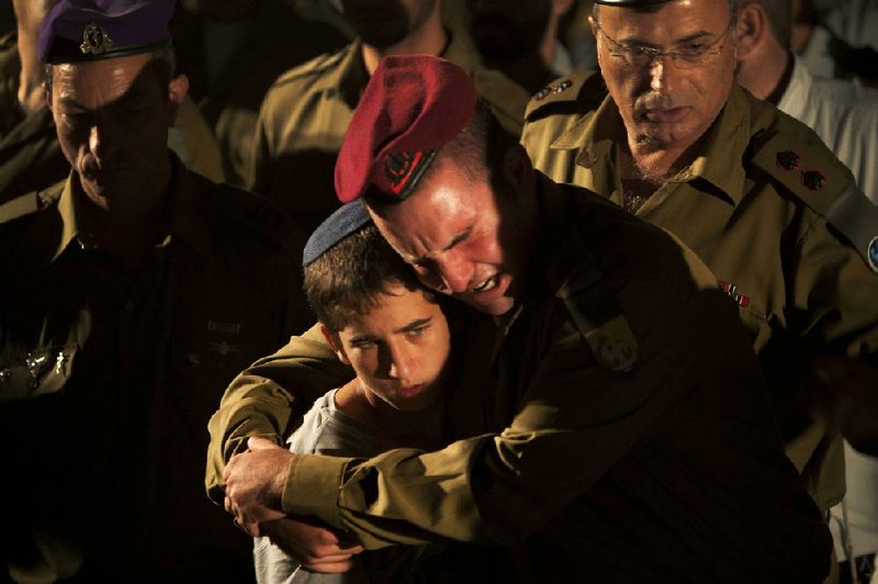 Israeli soldiers and relatives react during the funeral of Cpl. Netanel Yahalomi, 20, in the Israeli city of Modiin, early Sunday. Yahalomi was killed Friday in a shootout between Islamic militants and Israeli troops along Israel’s southern border with Egypt. 