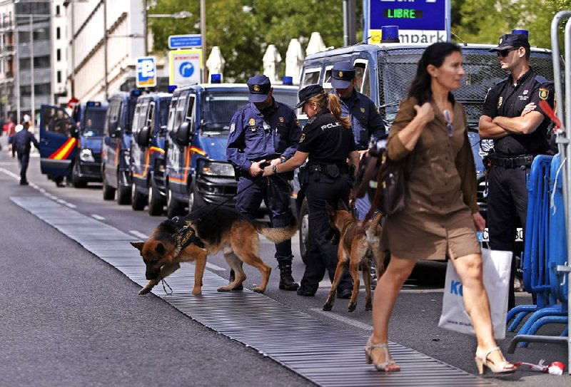 Police stand guard outside the parliament building in Madrid on Tuesday ahead of a demonstration against austerity measures announced by the Spanish government. 