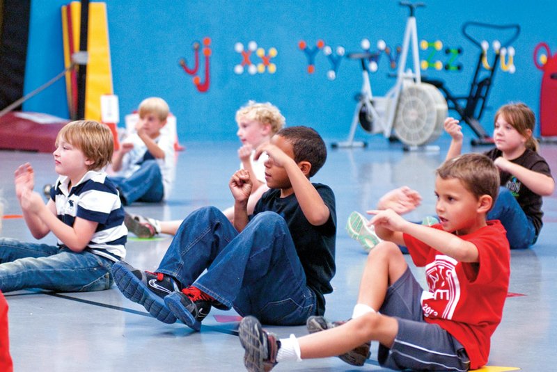 Second-graders at Eastside Elementary School in Cabot exercise during a physical education class. The class is part of the school district’s SPARK curriculum, which encourages movement by the students as a way to combat childhood obesity.