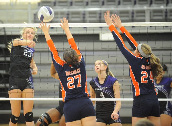 Cassidy Ginger, left, a Fayetteville junior, kills the ball past Rogers Heritage senior Emily Alderson, left, and sophomore Connor McNulty on Tuesday during play at Fayetteville.
FRESH START