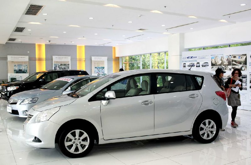 Toyota vehicles assembled by the Guangzhou Automobile Group Co. and Toyota Motor Co. Ltd. partnership are displayed in a showroom in Guangzhou, Guandong province, China. Analysts expect Toyota, Nissan and Honda will see lower production levels in China after anti-Japan protests. 
