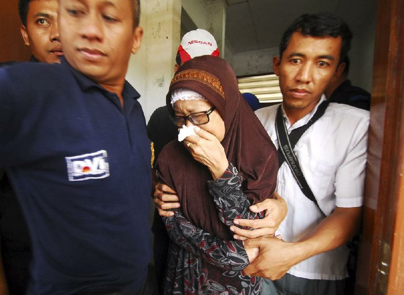 An Indonesian woman whose daughter was killed in a ferry accident weeps Wednesday at a hospital in Cilegon, Indonesia. 