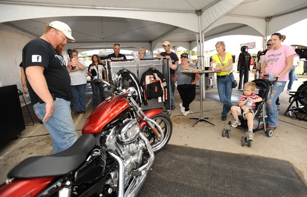 Gil Johnson, instructor for Harley-Davidson’s Rider’s Edge motorcycle safety program, speaks Wednesday during a riders seminar geared toward women at the Baum Motorcycle Village as a part of Bikes, Blues & BBQ in Fayetteville.