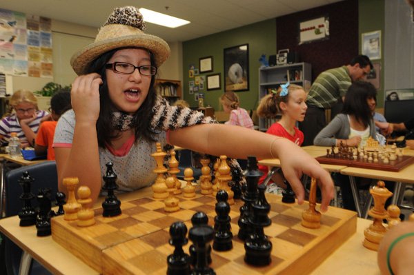 Sabrina DeJesus makes a chess move during a match Wednesday at Lingle Middle School in Rogers. Players get an early start, with chess matches starting at 7:30 a.m.