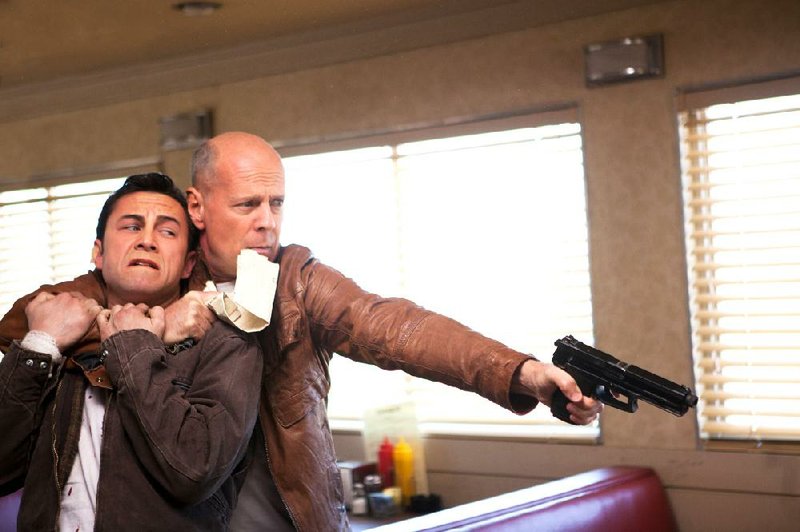 Old Joe (Bruce Willis) holds his younger self (Joseph Gordon-Levitt) hostage in Rian Johnson’s time travel noir Looper.

