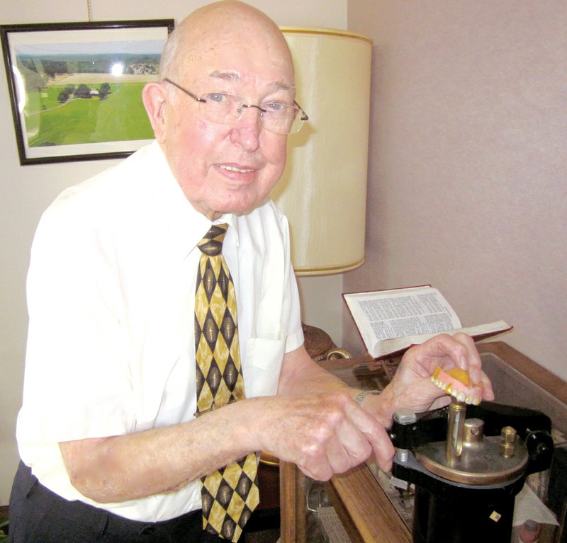 Dr. J.D. Patterson displays one of his father’s vulcanizers and the rubber dentures that it produced before rubber was abandoned in dentistry during the 1940s.