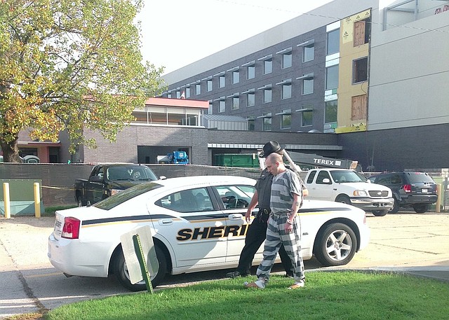 Darin Michael Etherton, 28, of Pea Ridge is escorted to a patrol car after pleading guilty to first degree murder in connection with the death of Brent Test. Etherton was sentenced to 30 years in prison.