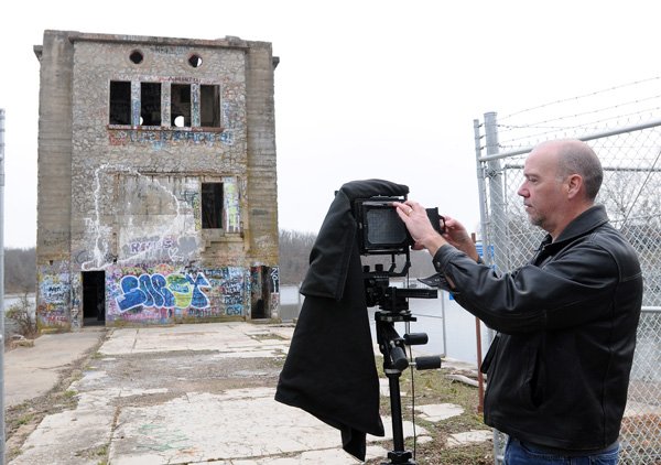 Joseph Murphey, a historical architect with the Army Corps of Engineers, changes the dark slide while taking photographs for the Library of Congress records on Feb. 7 in Monte Ne. 