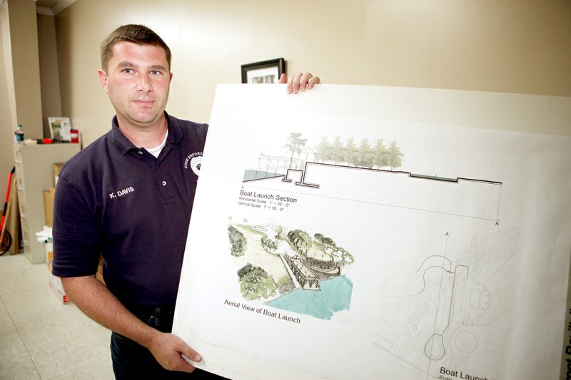 Kip Davis, Augusta city planner, shows drawings for a proposed city park in Augusta. The city recently acquired a bridge from 1929 that may be used as a pier in the park.