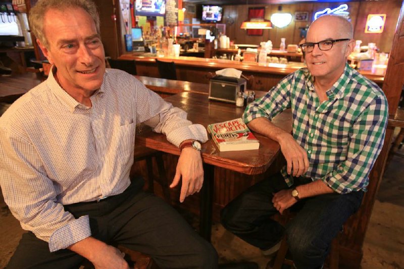 Rod Lorenzen (left) and Jay Jennings, publisher and editor of the new Charles Portis book Escape Velocity, re-create a moment from the book’s history. Jennings met Portis just about here at the Town Pump in Little Rock almost 30 years ago. Jennings has been collecting all he could find of Portis’ newspaper and magazine stories ever since — the makings of the new book, “a Charles Portis miscellany.”


