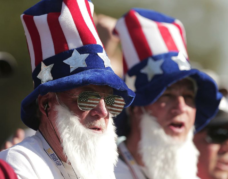 For some in the massive galleries at the Ryder Cup, Friday was dress-up day. Uncle Sam was a big theme, as with the two fans above, with some fans wearing stovepipe hats to accessorize the look. Others were draped in American flags, shirts that resembled flags and even red, white and blue pants. European fans were spotted dressed as European flags in yellow and blue and others were dressed like bullfighters, complete with capes that resembled the flags of Spain, and matador hats. 