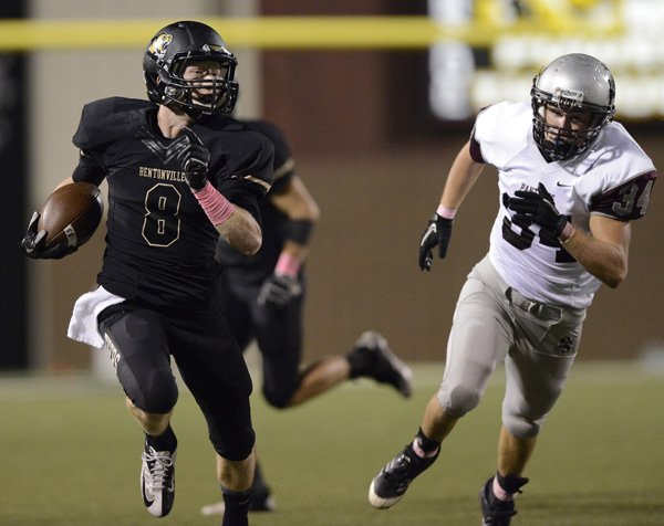 Austin Haggard of Bentonville returns a punt 54 yards for a touchdown Friday during the first quarter against Siloam Springs at Tiger Stadium in Bentonville. 