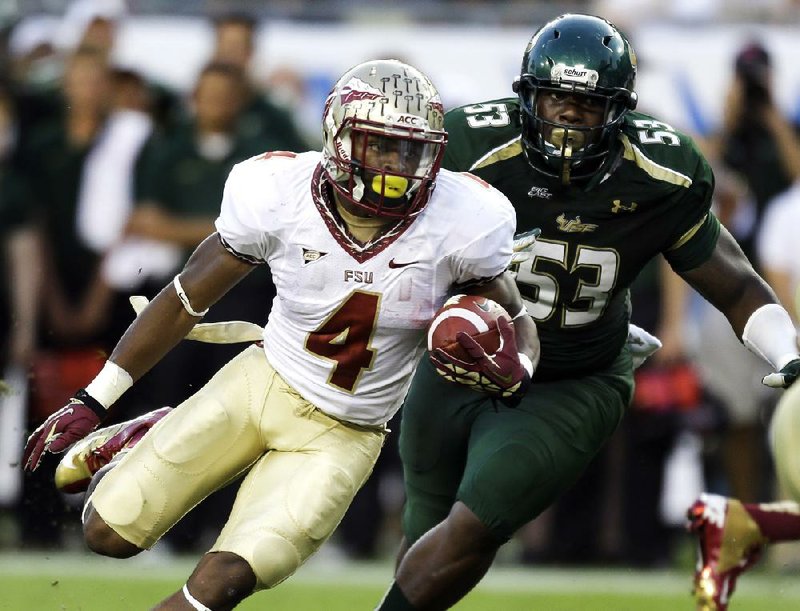 Florida State running back Chris Thompson (4) runs past South Florida defensive lineman Elkino Watson (53) during the second quarter of the No. 4 Seminoles’ 30-17 victory on Saturday in Tampa, Fla. 