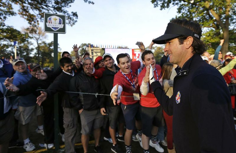 Fans greet Bubba Watson before Watson and Webb Simpson teed off against Ian Poulter and Justin Rose in Saturday’s first foursomes match.Watson teed off as fans cheered for the second day in a row. Poulter also got into the act, getting fans to cheer as he teed off. 