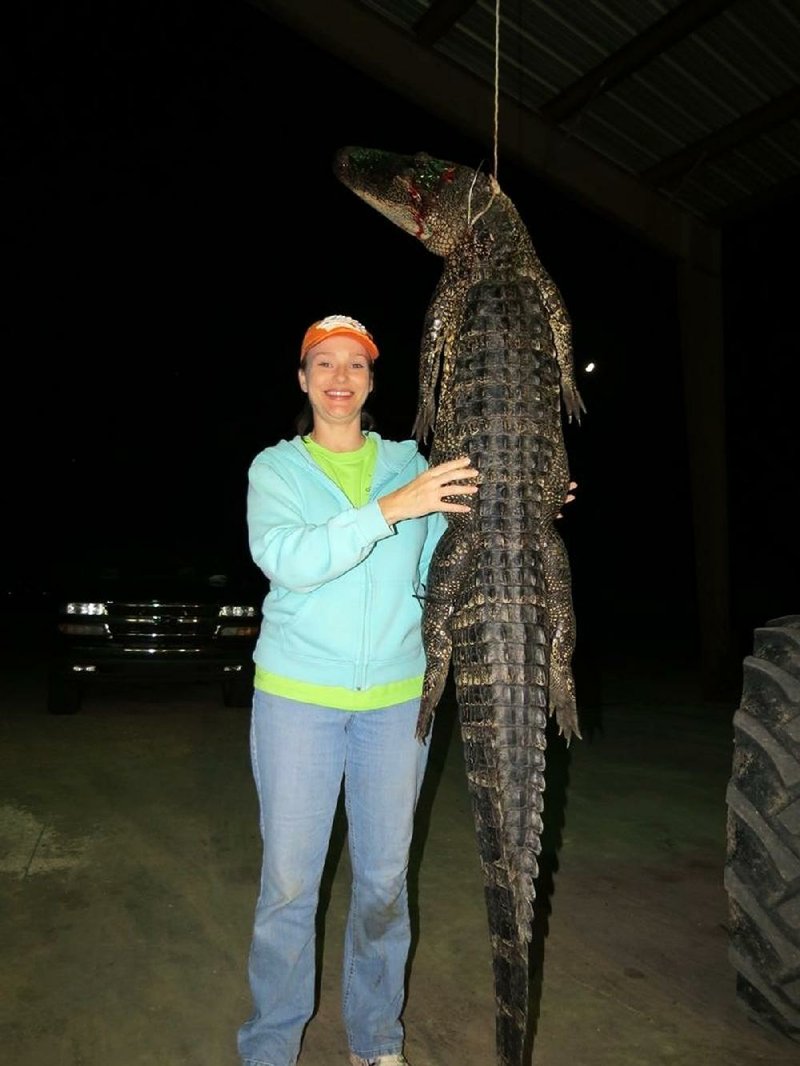 Rhonda Hampton of Lodge Corner became the first woman to kill more than one alligator in Arkansas when she took this 7-foot, 3-inch gator last weekend at a family reservoir in Arkansas County. 