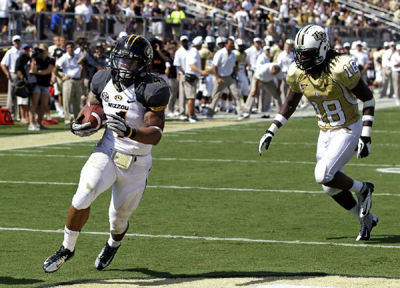 Missouri running back Kendial Lawrence (left) ran for 104 yards and a touchdown in the Tigers’ 21-16 victory Saturday over Central Florida in Orlando, Fla. 