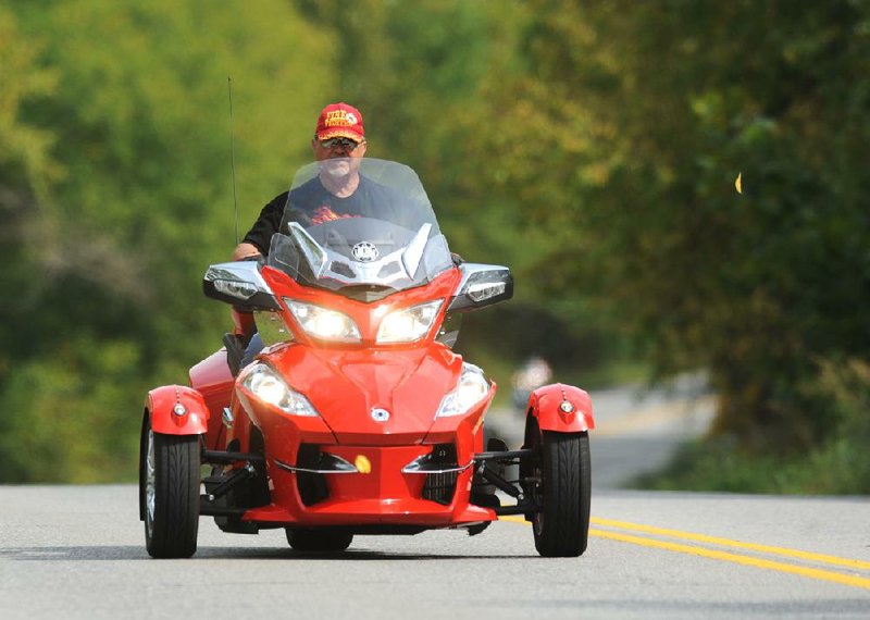 A motorcyclist works his Can-Am three-wheeler though a series of turns Friday on Arkansas 16 east of Fayetteville during the Bikes, Blues & BBQ motorcycle rally that ended Saturday. 