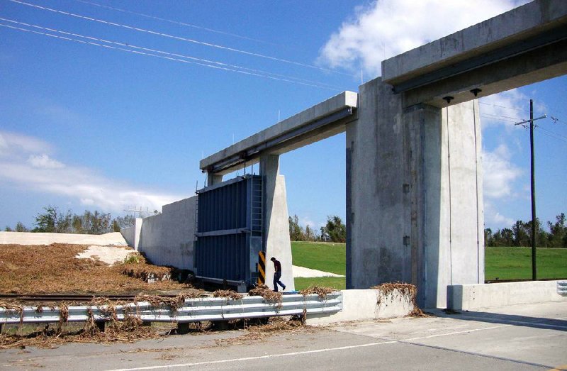 An inspector checks a New Orleans floodgate that helped keep out flooding from Hurricane Isaac. Those outside the New Orleans levee system are asking for flood-control measures as well. 