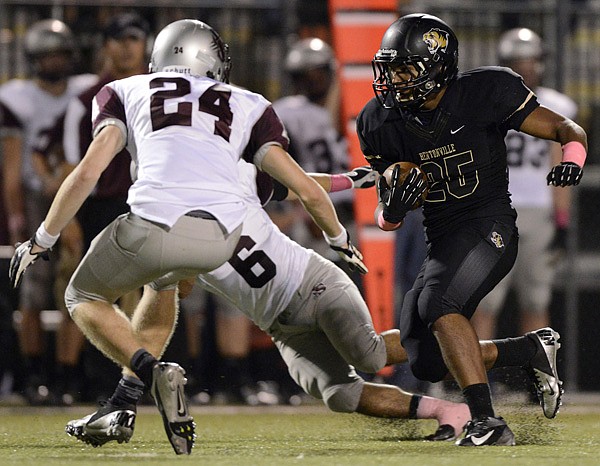 Dylan Smith, Bentonville running back, carries the ball Friday for a first down in the second quarter against Siloam Springs at Tiger Stadium in Bentonville.