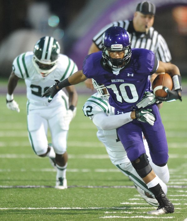 Fayetteville junior receiver Jordan Dennis is tackled by Muskogee (Okla.) senior safety Orion Ennis after making a catch Friday, Sept. 14, 2012, during the first half of play at Harmon Field.