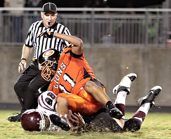 Gravette sophomore Cedric Duarte puts a stop to Gentry senior ball carrier Elijah Ramsey during play in Lions Stadium on Friday night. For the full story, see Page 1B