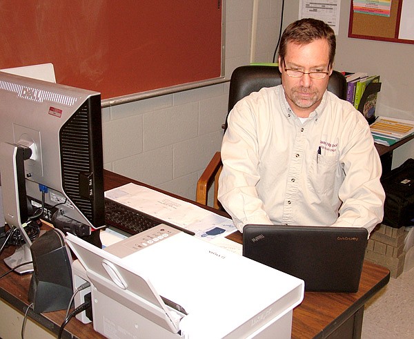 Gentry High School teacher Patrick Lanford works on a netbook computer at his desk on Sept. 27. Students use similar netbooks to complete all their work assignments online.