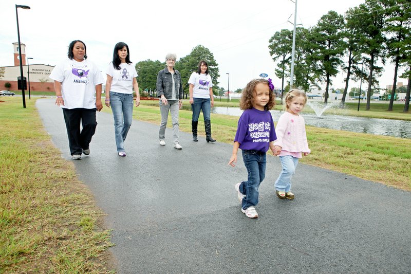 Shown walking along the track near the Jacksonville Community Center are, from the left, in the front, Ki’Nani Cantrall and McKelvey Bonhan; and in the second row, Cales Cantrall, Kimberly Stricklin, Pam Hall and Dana Gaines. The women are organizing a walk to raise awareness of Chiari malformation, a neurological disorder.