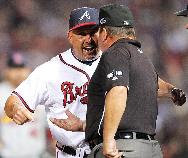 Atlanta Manager Fredi Gonzalez argues with umpire Sam Holbrook after an infield fly call in the eighth inning helped thwart a Braves rally in a 6-3 St. Louis wild-card playoff victory in Atlanta. 