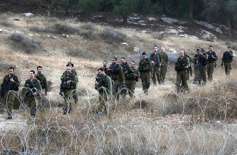 Israeli soldiers search Saturday for the remains of an unidentified drone shot down in southern Israel. The drone penetrated deep into Israeli airspace before fighter jets intercepted and shot it down.